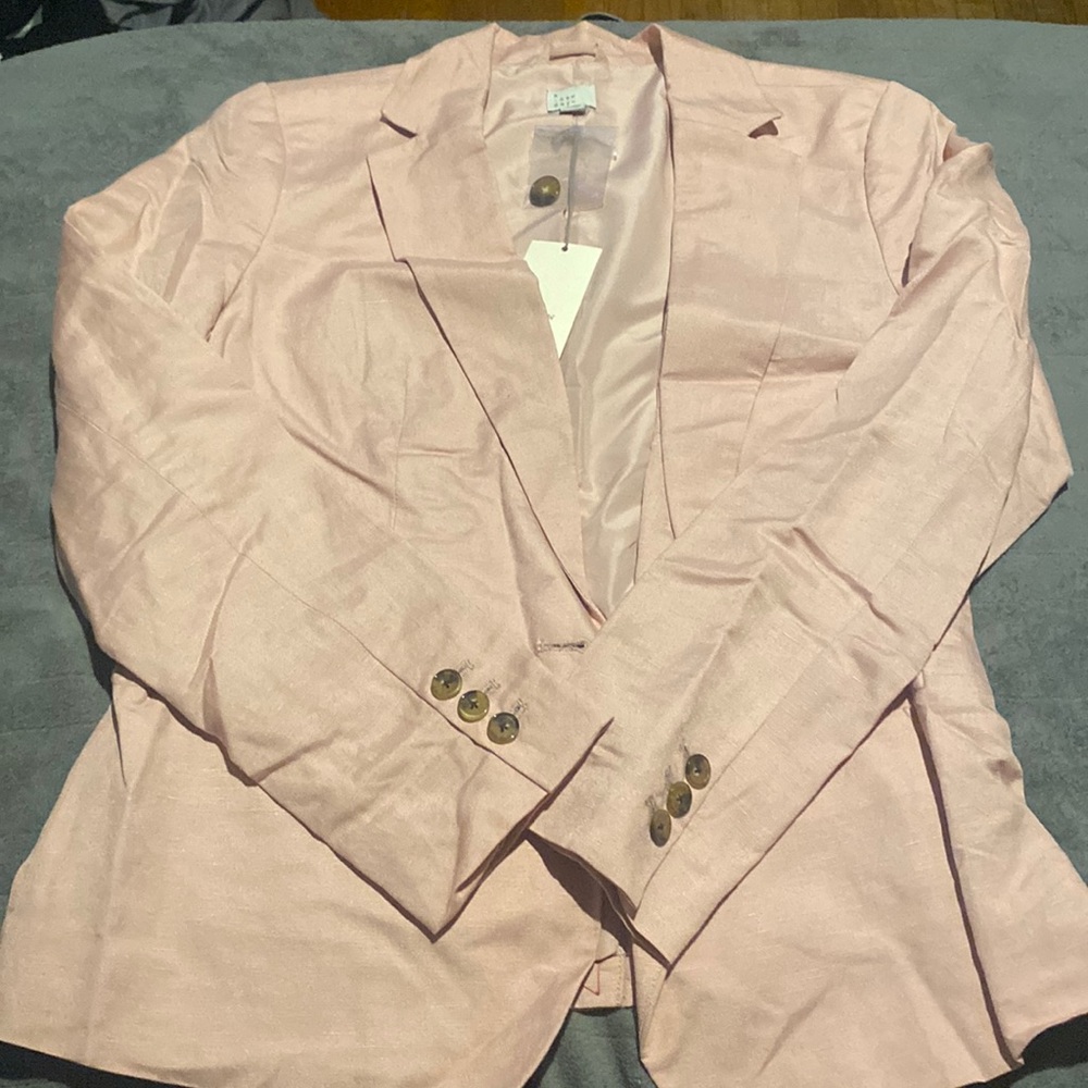 Light pink blazer with pockets and extra button. Never worn. Tags attached